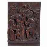 AN 18TH CENTURY CARVED OAK PANEL depicting acts of charity, 14cm wide x 19cm high