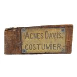 A BRASS NAMEPLATE for Agnes Davis, Costumier, 27.5cm x 15.5cm mounted on a later wooden board