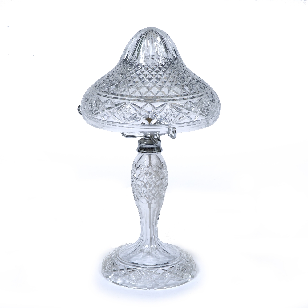 A TABLE LAMP with cut glass shade and body and on a spreading circular base, 26cm diameter x 49cm