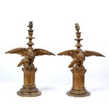 TWO SIMILAR CARVED GILTWOOD TABLE LAMPS each decorated with an eagle with spreading wings on a