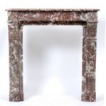 A RED MARBLE CHIMNEY PIECE OR FIRE SURROUND with pilaster columns to either side, 117cm wide x 33.