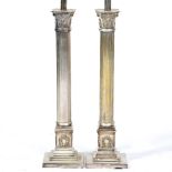 A PAIR OF SILVERED METAL TABLE LAMPS in the form of reeded classical columns, each on a stepped