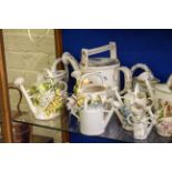 A COLLECTION OF PORCELAIN WATERING CANS to include two Dresden examples with handpainted floral