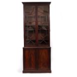 A GEORGE III MAHOGANY LIBRARY BOOKCASE with astragal glazed upper section enclosing adjustable