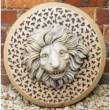 A VICTORIAN CIRCULAR STONEWARE PLAQUE decorated with a lion mask with background of a spotted