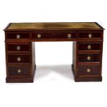 A LATE 19TH / EARLY 20TH CENTURY MAHOGANY PEDESTAL DESK with a leather inset top, nine drawers