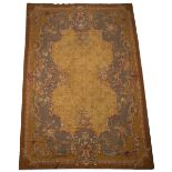 AN 18TH CENTURY FRENCH STYLE GOLD GROUND NEEDLEWORK SMALL CARPET with flowers to the central field