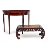 A CHINESE HARDWOOD LOW TABLE with scrolling ends and foliate carved undertier, 84cm wide x 41cm deep
