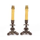 A PAIR OF 19TH CENTURY BRONZE CANDLESTICKS on tripod bases, later converted for use as table