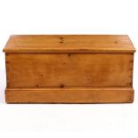 A PINE BLANKET BOX with dovetail joints to the corners and iron carrying handles to the side, with