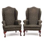 A PAIR OF GEORGIAN STYLE WING BACK ARMCHAIRS with fleur de lis decorated green ground material and