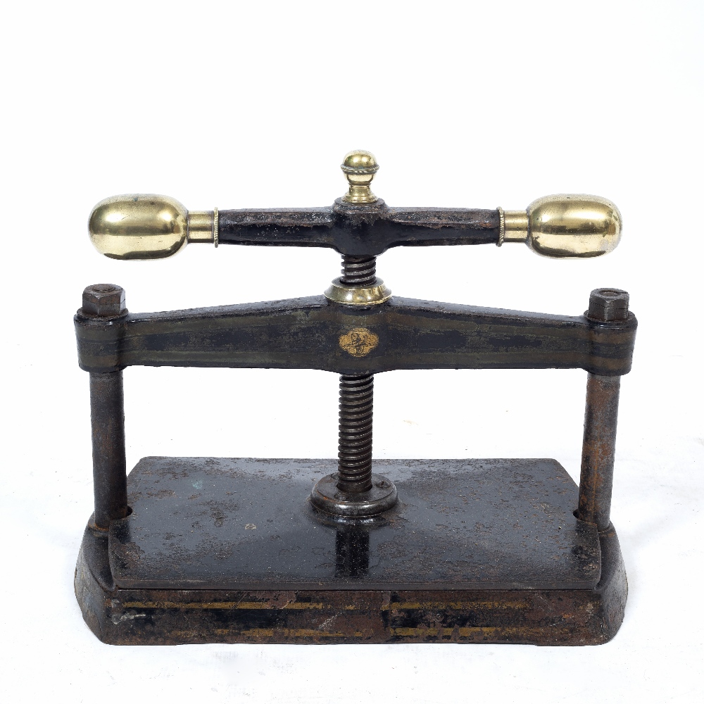 A VICTORIAN BLACK PAINTED CAST IRON BOOK PRESS with brass terminals, 47cm wide x 38cm high At