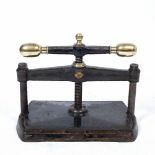 A VICTORIAN BLACK PAINTED CAST IRON BOOK PRESS with brass terminals, 47cm wide x 38cm high At