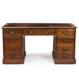 A MAHOGANY PEDESTAL DESK with leatherette inset top and various drawers around the central kneehole,