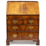 A GEORGIAN STYLE MAHOGANY BUREAU circa. 1940, the fall front opening to reveal pigeon holes, drawers