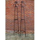 A PAIR OF WROUGHT IRON TRIANGULAR SECTION GARDEN OBELISKS each with scrolling finials, 230cm high (