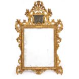 A GEORGE III GILT PIER GLASS with shell crest, an upper glazed slip above scrolling decoration