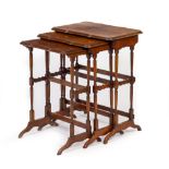 A WALNUT VENEERED NEST OF THREE SERPENTINE FRONTED OCCASIONAL TABLES with quarter veneered top,
