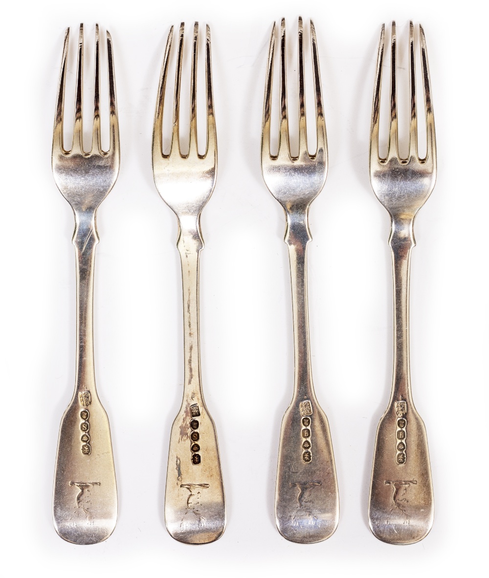 A SET OF FOUR GEORGE III FIDDLE PATTERN SILVER TABLE FORKS by Solomon Haugham, with stags head crest