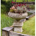 A SET OF FOUR RECONSTITUTED STONE GARDEN URNS