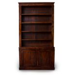 A 19TH CENTURY CONTINENTAL LIBRARY BOOKCASE the upper section with four open adjustable shelves over