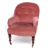 A VICTORIAN PINK DRAYLON UPHOLSTERED LOW CHAIR with turned mahogany legs terminating in brass