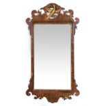 A GEORGIAN STYLE MAHOGANY FRET FRAMED WALL MIRROR with gilt ho-ho bird crest, 50cm wide x 93.5cm