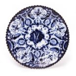AN EARLY 18TH CENTURY DUTCH DELFT BLUE AND WHITE PLATE with a wavy edge, 25.5cm diameter At present,