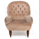 A VICTORIAN BUTTON UPHOLSTERED LOW CHAIR with turned supports, brass and ceramic casters, 73cm