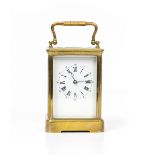 A BRASS CARRIAGE CLOCK OR TIMEPIECE with enamel dial, unsigned, 9.5cm wide x 8.2cm deep x 18cm