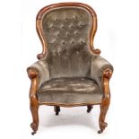 A VICTORIAN WALNUT FRAMED UPHOLSTERED ARMCHAIR with scrolling arms, cabriole legs and brass and