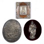 A PRESSED WHITE METAL PANEL depicting Mary and Christ, set on an oval velvet mount, unframed, 14.5cm