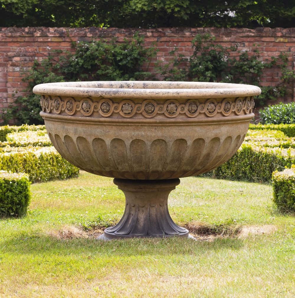A VICTORIAN LARGE BUFF TERRACOTTA URN OR FOUNTAIN BOWL with guilloche banding and fluted