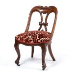 A VICTORIAN OAK SIDE CHAIR with shaped carved back and serpentine overstuffed upholstered seat