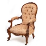 A VICTORIAN CARVED WALNUT FRAMED UPHOLSTERED OPEN ARMCHAIR with scrolling arms, cabriole legs and