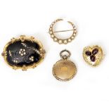 A SMALL YELLOW METAL POSSIBLY VICTORIAN HEART SHAPED BROOCH set with three cabochon polished