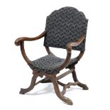 A CONTINENTAL WALNUT X FRAMED OPEN ARMCHAIR with shaped back, scrolling arm terminals and