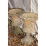 A PAIR OF CAST RECONSTITUTED STONE GARDEN URNS of campana form with fluted bodies and square