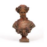 A TERRACOTTA COLOURED CAST COMPOSITE BUST of a girl with flowers in her hair, 31cm wide x 46cm high,
