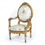 A MID 19TH CENTURY STYLE CARVED GILT ARMCHAIR with oval back, upholstered arms, shaped seat and