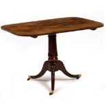 A GEORGE III MAHOGANY TILT TOP TABLE with a turned and reeded stem, tripod base and brass casters,