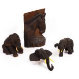 A SMALL CARVED HARDWOOD SEATED ELEPHANT 20cm high together with a further elephant with extended