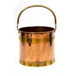 A 19TH CENTURY COPPER AND BRASS BOUND FIRE BUCKET with a loop handles, 31.5cm diameter x 33cm high