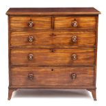 A VICTORIAN MAHOGANY CHEST OF TWO SHORT AND THREE LONG DRAWERS with turned knob handles and splaying