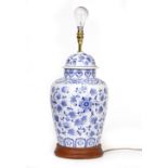 A CONTEMPORARY TABLE LAMP in the style of a Oriental blue and white ginger jar, on a turned wooden