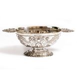 A VICTORIAN EMBOSSED SILVER FOOTED DISH of oval form with cast handles, marks for London 1861 and