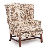 A ROSEWOOD OPEN ARMCHAIR with decorative inlay to the back, overstuffed upholstered seat, carved