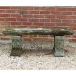 A CAST RECONSTITUTED STONE RECTANGULAR TOPPED BENCH with scrolling supports, 122cm long x 41cm