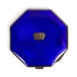 A 1930s BLUE ENAMEL AND ENGINE TURNED SILVER COMPACT of octagonal form with a central crest,