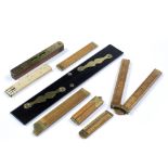 A COLLECTION OF 19TH CENTURY AND LATER FOLDING RULES in boxwood ivory and ebony, with brass mounts